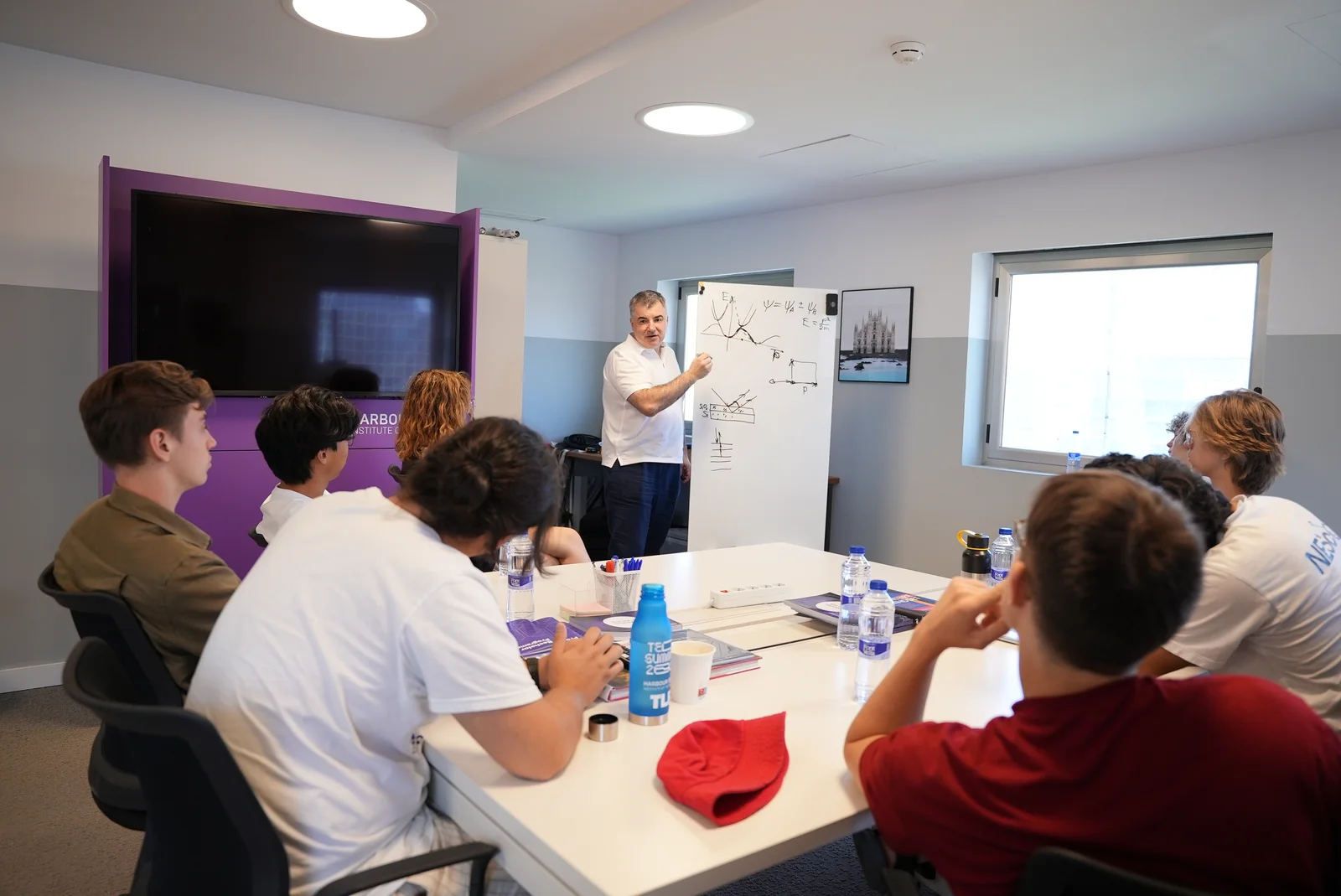 A student sharing ideas at a whiteboard